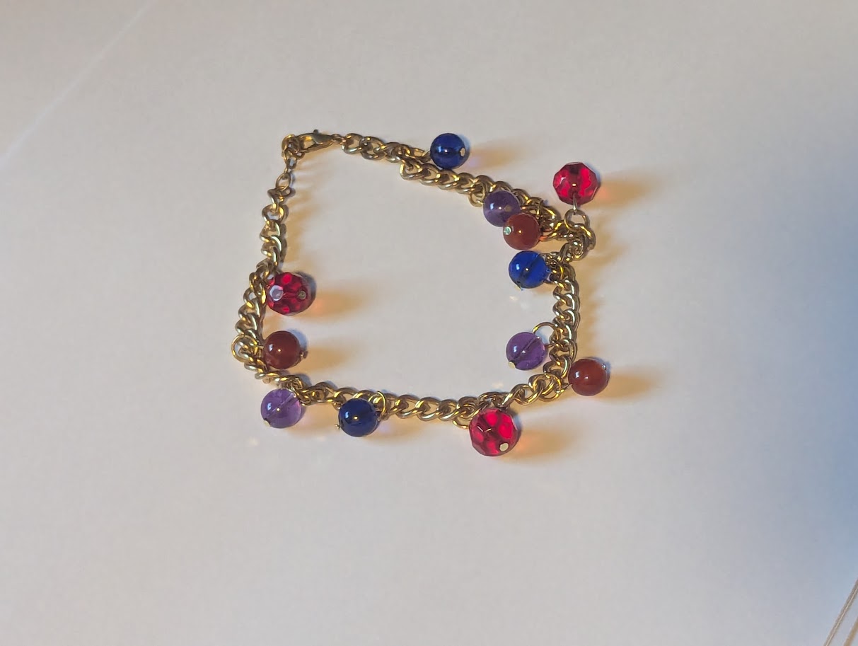 Red,Purple,Blue, and Orange beads on a gold colored Chain Bracelet