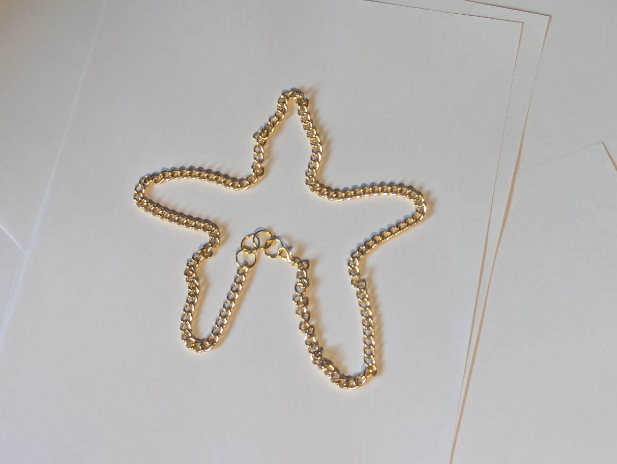 Gold Colored Chain Necklace shaped like a star
