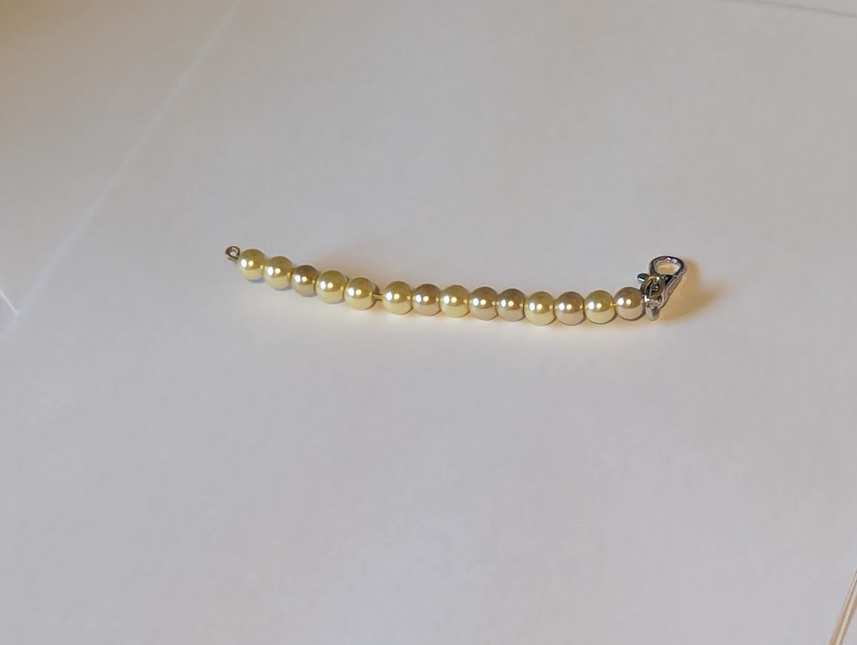 Gold colored beads on wire fidget