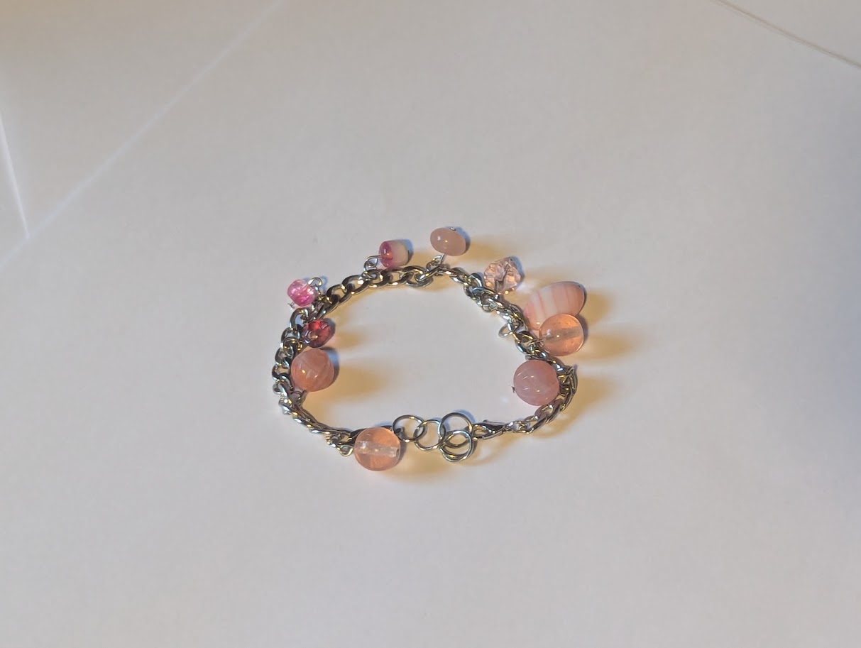 Pink beads on silver colored chain bracelet