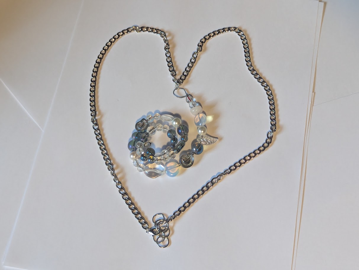 A big spriral of beads on a silver colored chain